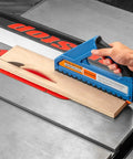 Slick D Handle Narrow Push Block For Table Saw Safety Keeps Your Digits Off Blades With Rock Solid Non Slip Base And Spring Loaded Tailhook For Tight Rip Cuts And Smooth Woodworking used on wood slab in cutting process.