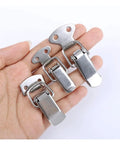 Hand holding spring loaded stainless steel toggle latch kit for cabinets and sliding enclosures 6 pack cap catch design hardware