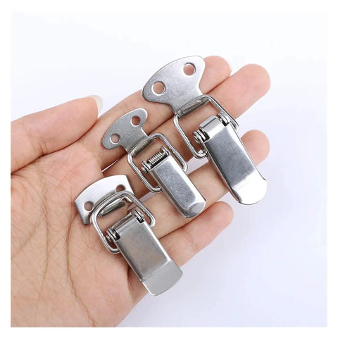 Hand holding spring loaded stainless steel toggle latch kit for cabinets and sliding enclosures 6 pack cap catch design hardware