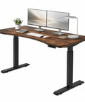 63 By 30 Inch Heavy Duty Dual Motor Electric Standing Desk Slick Curve Top with dual monitors and lamp on wooden surface.