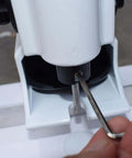 Adjusting Heavy Duty Portable Handheld Paper Hole Punch With 4mm 5mm 6mm 7mm 8mm Holes using a tool, close-up view