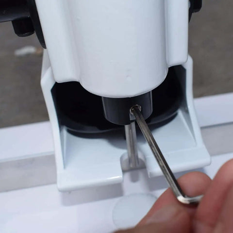 Adjusting Heavy Duty Portable Handheld Paper Hole Punch With 4mm 5mm 6mm 7mm 8mm Holes using a tool, close-up view