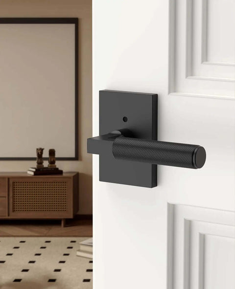 Black Privacy Door Handle Set With Keyless Interior Lock installed on a white door, featuring an easy privacy button for bedrooms.