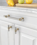 Six Pack 5 Inch 128mm Gold and Brushed Satin Nickel Cabinet Pulls Heavy Duty Solid Kitchen Handles installed on white cabinets.