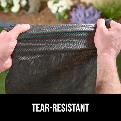 Hands stretching Heavy Duty Tough As Nails Weed Barrier Fabric 3 Ft By 50 Ft Ground Cover For Garden Beds And Mulch, 3.2 Oz Woven Landscape Cloth
