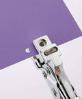 3 In 1 Badge Slot Hole Punch cutting round hole in purple cardstock, all-metal handheld tool for PVC, laminated photos, business cards
