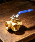 Built Tough Forged Brass Three Way Valve T Type Half Inch Bsp Thread Heavy Duty Plumbing Connector with blue handle.