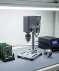 Compact Mini Drill Press Desk Machine Adjustable 12-24V Power Stable Bench Tool With 0.6-6mm Chuck in a workshop setup.