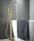 Brushed Gold Freestanding Bathtub Faucet Floor Mount Tub Filler With Single Handle Brass Tap beside white bathtub
