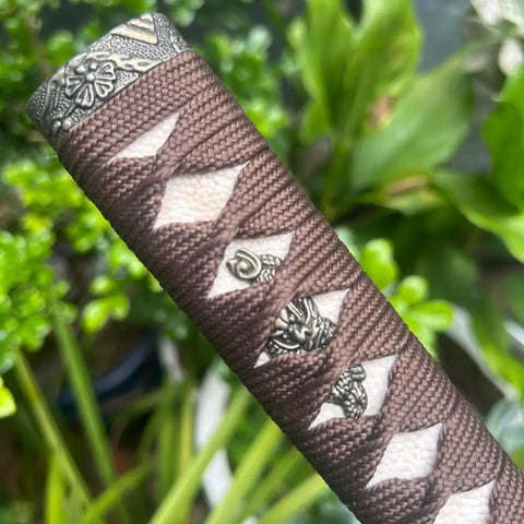 Close-up of sword handle tsuka with real samegawa stingray skin and alloy copper iron fittings dope grip for authentic samurai look