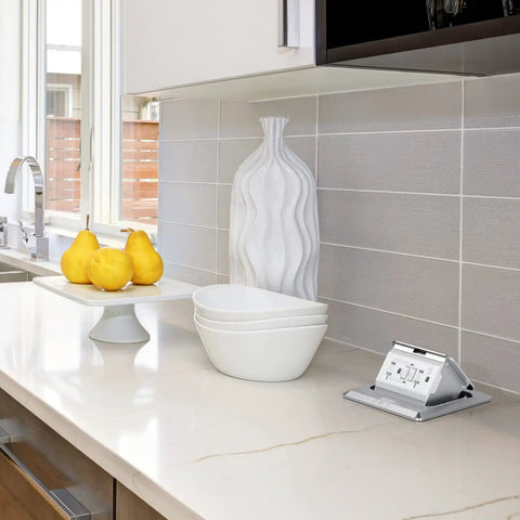 Kitchen countertop with Go To Pop Up Floor Outlet Box With 20 Amp Stainless Steel GFCI Receptacle Weather Resistant.