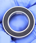Close-up of Sealed Cartridge Bearing Set 18 X 30 X 7 mm MR18307 RS 5 Pack For Bike Hubs With LBlu Seals, held with gloves