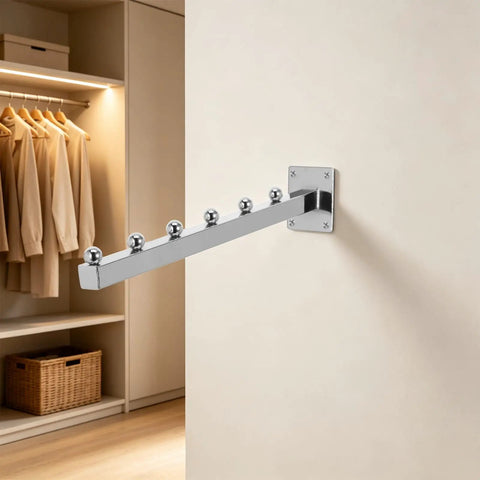 Heavy Duty Wall Mount Clothes Rack With Waterfall Hooks in aluminum on a beige wall with six ball slatwall hangers.