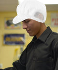Person wearing Hella Breathable Antistatic Mesh Protective Cap With Knockout Grip For Electronics Shops And Cleanrooms.