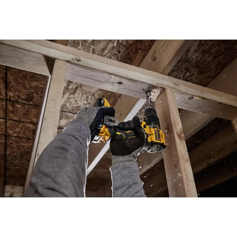 Close-up of hands using a Compact 20V Max Brushless Cordless Hammer Drill with ratcheting chuck for overhead drilling.