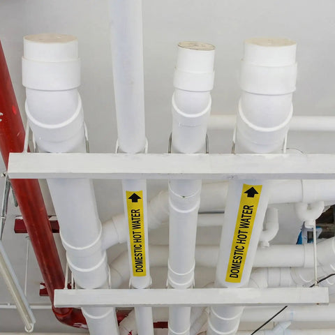 Domestic Hot Water Pipe Label Roll With Self Sticking Markers, 1 Inch High By 8 Inch Wide Yellow Plastic Film, Easy Peel And Apply, 25 Labels Per Roll For A No Fuss, Quick Identification Of Pipes on white pipes