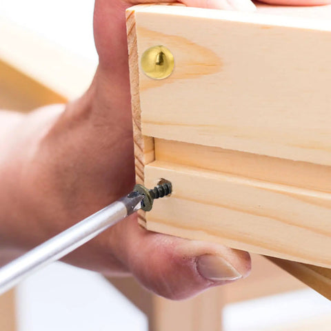 Person using a screwdriver on Top Shelf Vintage Style Brass Screws With Flush Caps, Self Tapping Decorative Fasteners For Antique Cabinets And Wooden Boxes, Straight Up 15mm Gold Finished Hardware Pack Of 16.