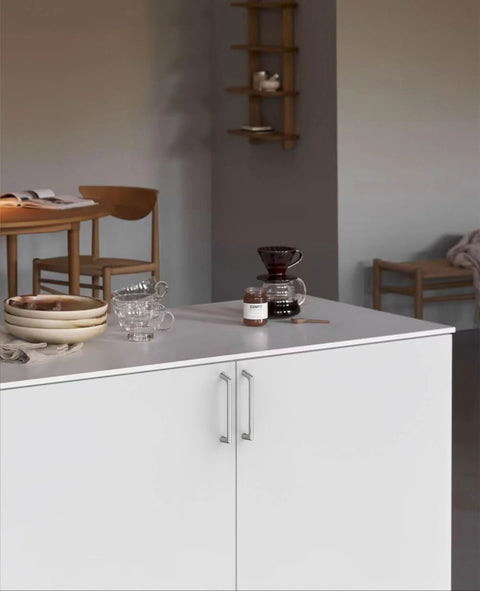 Modern kitchen island with 10 Pack 5 Inch Cabinet Handles Brushed Satin Nickel Zinc Alloy Pulls for cupboards in a cozy setting.