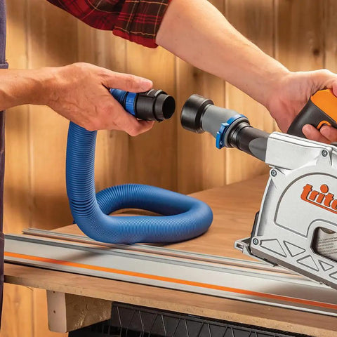 Person connecting a 1-1/2 Inch ID FlexiPort Quick Connect Dust Collector Adapter With Swivel And Elbow to a power tool on a workbench