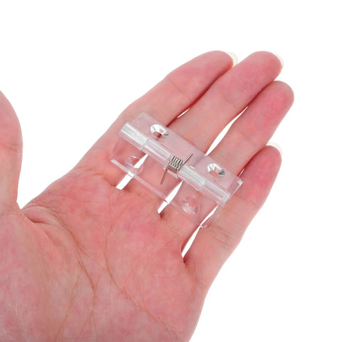 Two Pack Stainless Steel Hidden Door Hinges With Automatic Self Closing Spring shown in hand for size reference.
