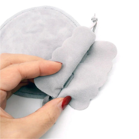 Close-up of hand holding gray velvet jewelry pouch from Velvet Jewelry Pouch Set, 60 Pack Small Drawstring Pouches for Rings, Earrings, Bracelets.