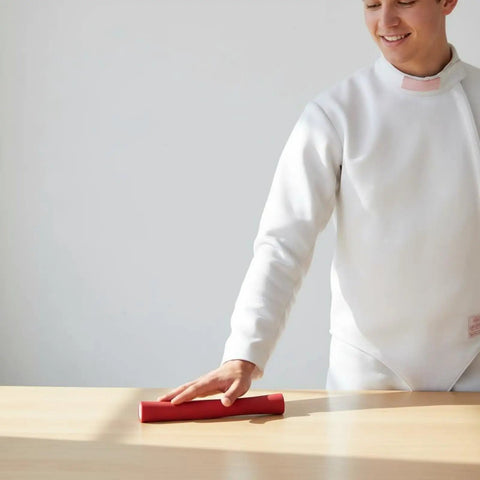 Fencing Handle Replacement Grip for Foil Epee Cutlass on table, red ergonomic design held by fencer, lightweight 50g