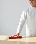 Person with red Universal Fencing Handle Rubber Grip, Ergonomic Lightweight Replacement For Foil, Epee, And Sabre on table