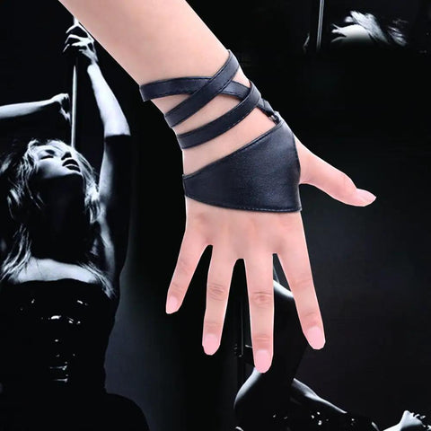 Dope Women Fingerless Gloves Crafted From Supple Faux Pu Leather For Nightouts And Punk Scenes Ultra Flexible Half Palm Wrist Cuff In Classic Matte Black Finish on a hand.