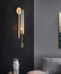 Gold Vintage Wall Sconce with Prismatic Clear Glass Tube (Metal Lamp Body) mounted on a wall, featuring a clear glass tube and gold finish.