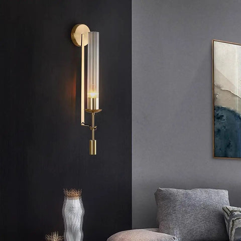 Gold Vintage Wall Sconce with Prismatic Clear Glass Tube (Metal Lamp Body) mounted on a wall, featuring a clear glass tube and gold finish.