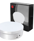 Herxsin Electric Rotating Display Stand 360 Degree Motorized Turntable With Usb Power Cable Showcase For Jewelry Watch Models And Photography Products Smooth Spin White Finish next to its box.