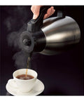 10 Cup Coffee Maker With Fresh Brew Plus Thermal Carafe Delivers Hot Coffee At 200 Degrees Fahrenheit Easy Setup For Strong Or Concentrated Ice Brew Stainless Steel And Black Finish A Real Game Changer pouring from thermal carafe into a white cup