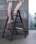 Woman standing on Smooth Operator Electric Attic Ladder With Remote Control and Heavy Duty Handrail in a modern interior.