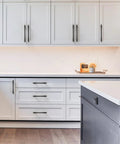 Matte Black Cabinet Pulls 5 Inch 128mm Hole Center 10 Pack Drawer Handles For Kitchen Cabinets And Bathroom Vanity Doors Hardware With Durable Construction And Easy Installation ZH0074 installed on white cabinets in kitchen setting.