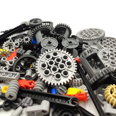 Pile of assorted gears, axles, and connectors from Tech Gear Kit With 116 Pieces For DIY Ready Builds Compatible With Mindstorms.