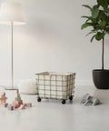 Heavy Duty Rolling Storage Basket For Toys, Smooth Swivel Caster Wheels Organizer with beige canvas liner, in a modern playroom.