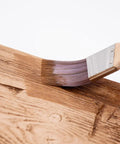 4 Oz Champagne Mist Touch Up Paint Kit For Faux Wood Beams And Trim Includes Custom Color Matching Tints To Repair Scuffs And Chips With No Sweat For A Slick Home Upgrade In Minutes, brush applying paint on faux wood surface.