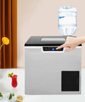 Two In One Countertop Cube Maker And Crushed Ice Crusher With Bright LCD Display For Rapid Party Mixing Craft Cocktails And Zero Drama Hosting Any Weekend Hangout, showcased with a water bottle and drinks.