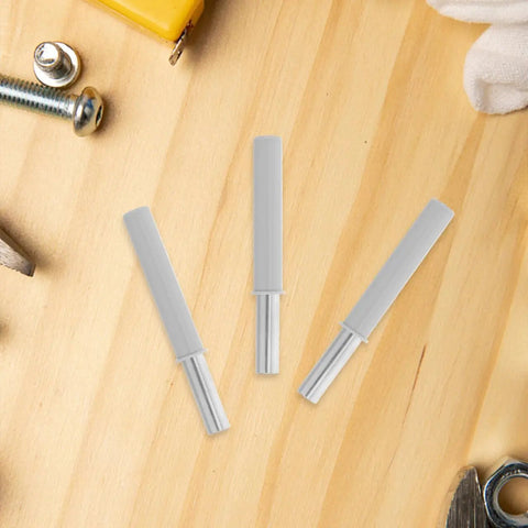 Smooth As Butter Soft Close Dampers For Trash Cans And Cabinet Doors 6 Pack showing grey ABS housing pieces on a wood surface.
