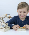 Child using Hands On Robotic Arm Kit For Kids Teens And Adults A Real STEM Toy With Motors Microcontroller Boards And Wires Learn Circuits