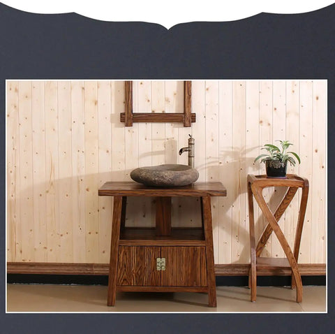 Wooden washstand with stone bowl, plant stand beside, vintage style against wooden paneling wall