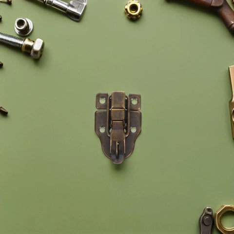 Get Your Antique Duckbill Toggle Latches For Secure Jewelry Boxes With Heavy Metal Hasp Catches That Keep Treasures Safe And Add Vintage Flair To Any Craft Project Or Treasure Chest Build bronze metal latch with four screw holes on green background