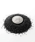 Thermally Activated GAC Carbon Filter granules with a quarter for size comparison, ideal for 3D printers and laser engravers, 1 lb pack.