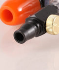 Close-up of Khbyt Tube Cooling Vest Accessory connector with orange nozzle and black fitting for industrial use.