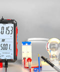 Upgraded FS899L Digital Multimeter with USB Rechargeable Power and Smart Auto Display measuring AC current next to light bulb.