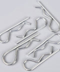 Close-up of R Shape Cotter Pins Set 150 Pieces Carbon Steel Small Metal Spring Pins scattered on a surface.