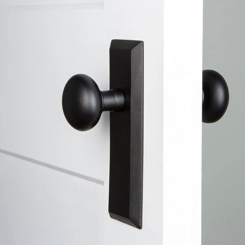 Keep Plate With Keep Knob Set In Black Iron For Modern Doors installed on a white door, matte black finish, durable steel construction
