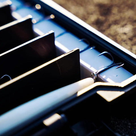 Close-up of BallistiX Twitch Tackle Tray For Jerkbaits And Topwaters Waterproof Lure Box interior dividers holding fishing lures.