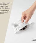 Heavy Duty Starfish Hair Catcher With Rock Solid Suction Cups For Bathtub Drains in use with suction pads on drain.