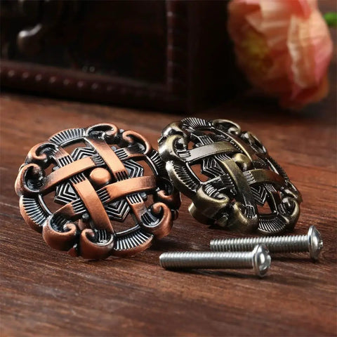 Old School Antique Brass Hollow Door Knob For Cabinets And Drawers with screws, detailed vintage design, on wood surface.